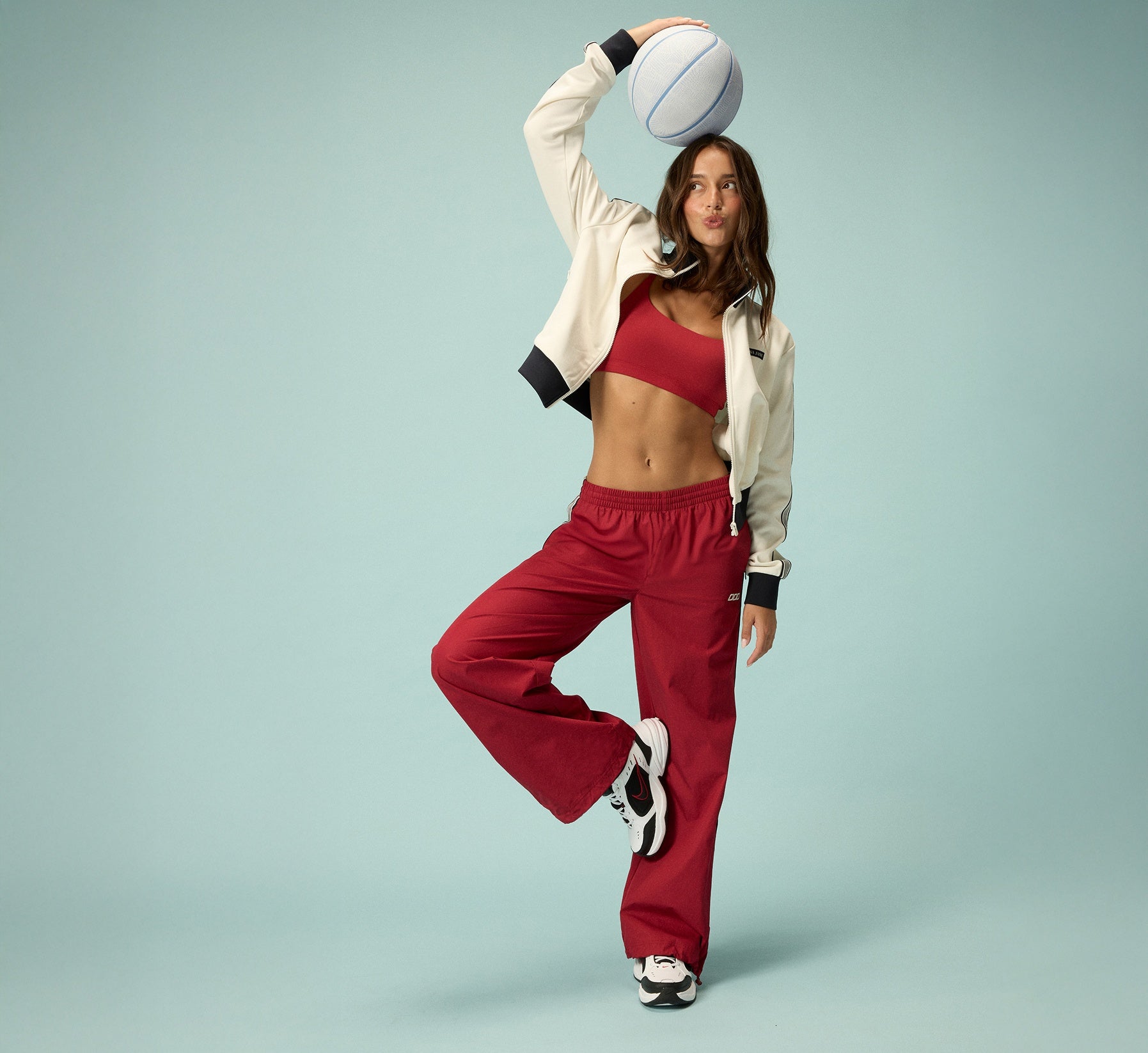 Woman wearing Lorna Jane Activewear, posing with a ball