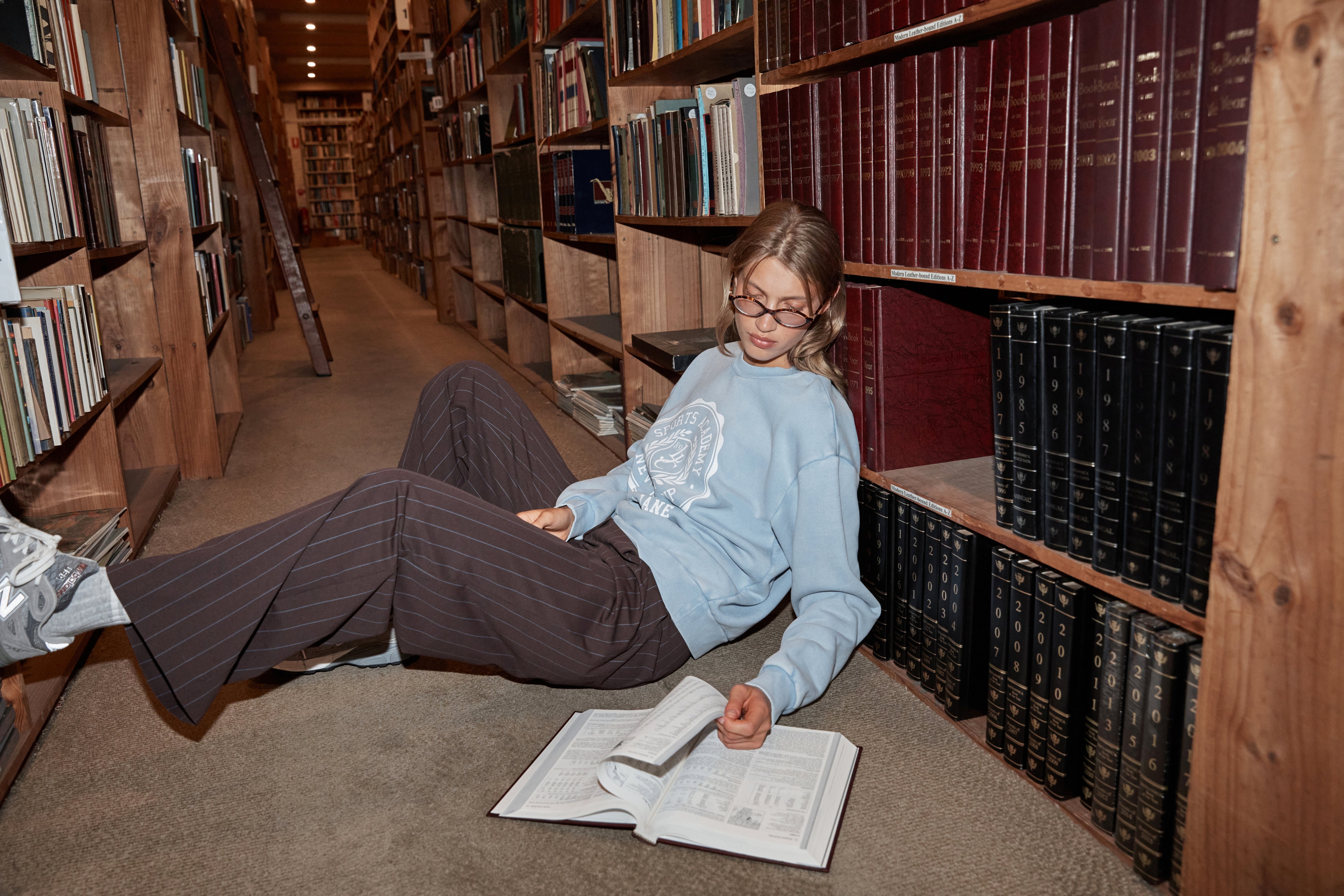 Woman wearing Lorna Jane pants and sweater, at the library