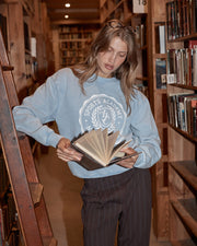 Woman wearing Lorna Jane pants and sweater, at the library