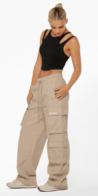woman wearing a strappy black tank top and off white cargo pants