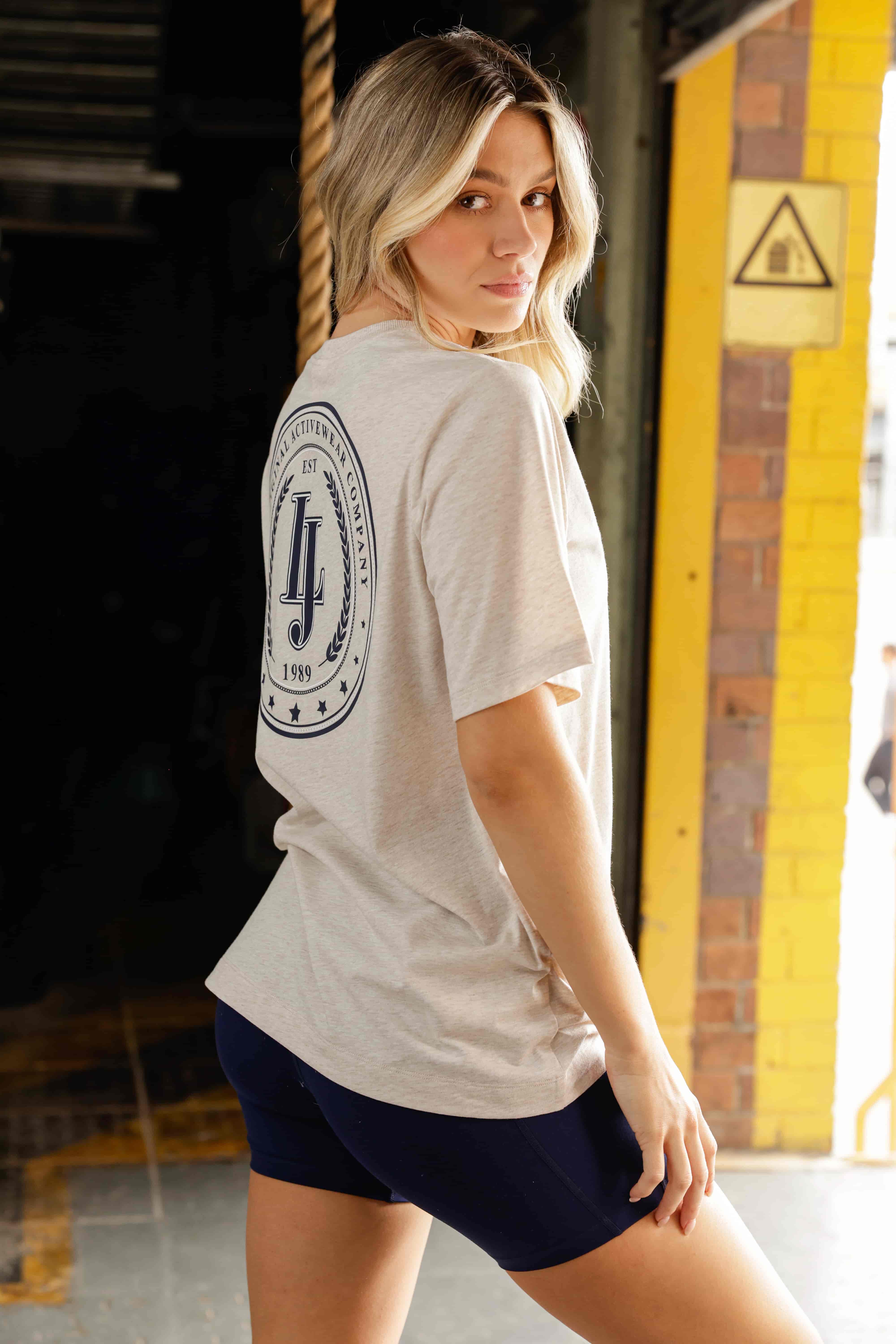 Back shot of modeal wearing oversized tee with large lorna jane circlular graphic on back