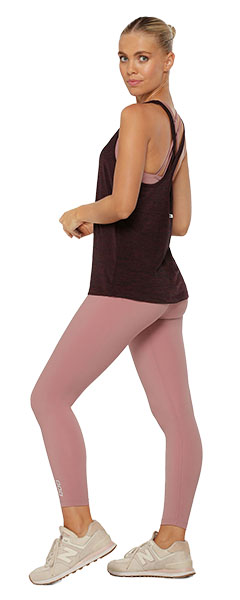 a woman wearing pink leggings and a red tank top