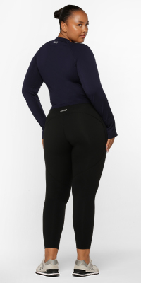 woman wearing a black long sleeve top and black ankle biter leggings