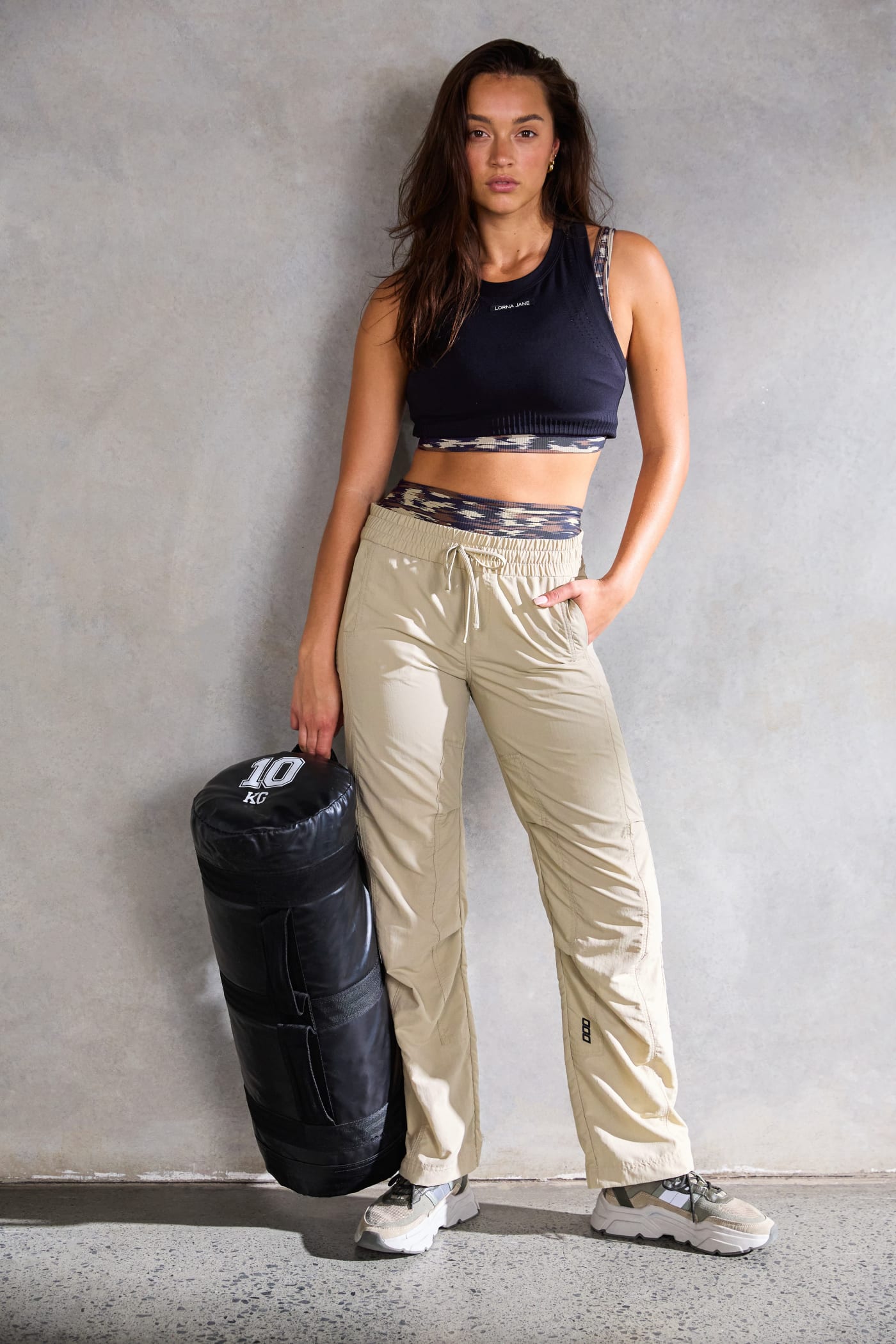 A front shot of a model wearing khaki active pants.